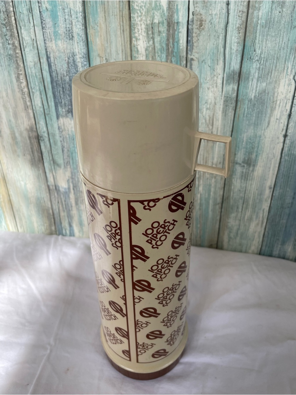 Vintage thermos features branding for 100 Pipers Scotch whisky